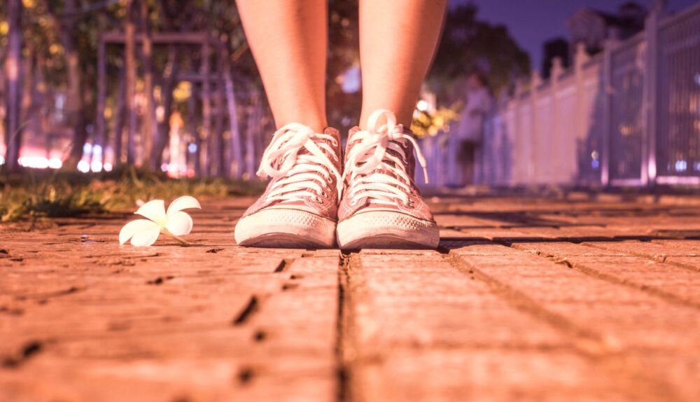 Woman's feet on pavment, ready for a prayer walk